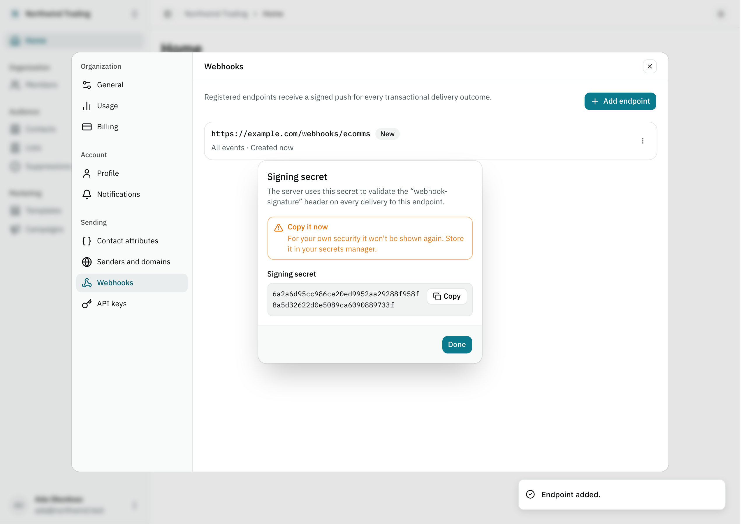 The dialog revealing a freshly registered webhook endpoint's signing secret, with a button to copy it.