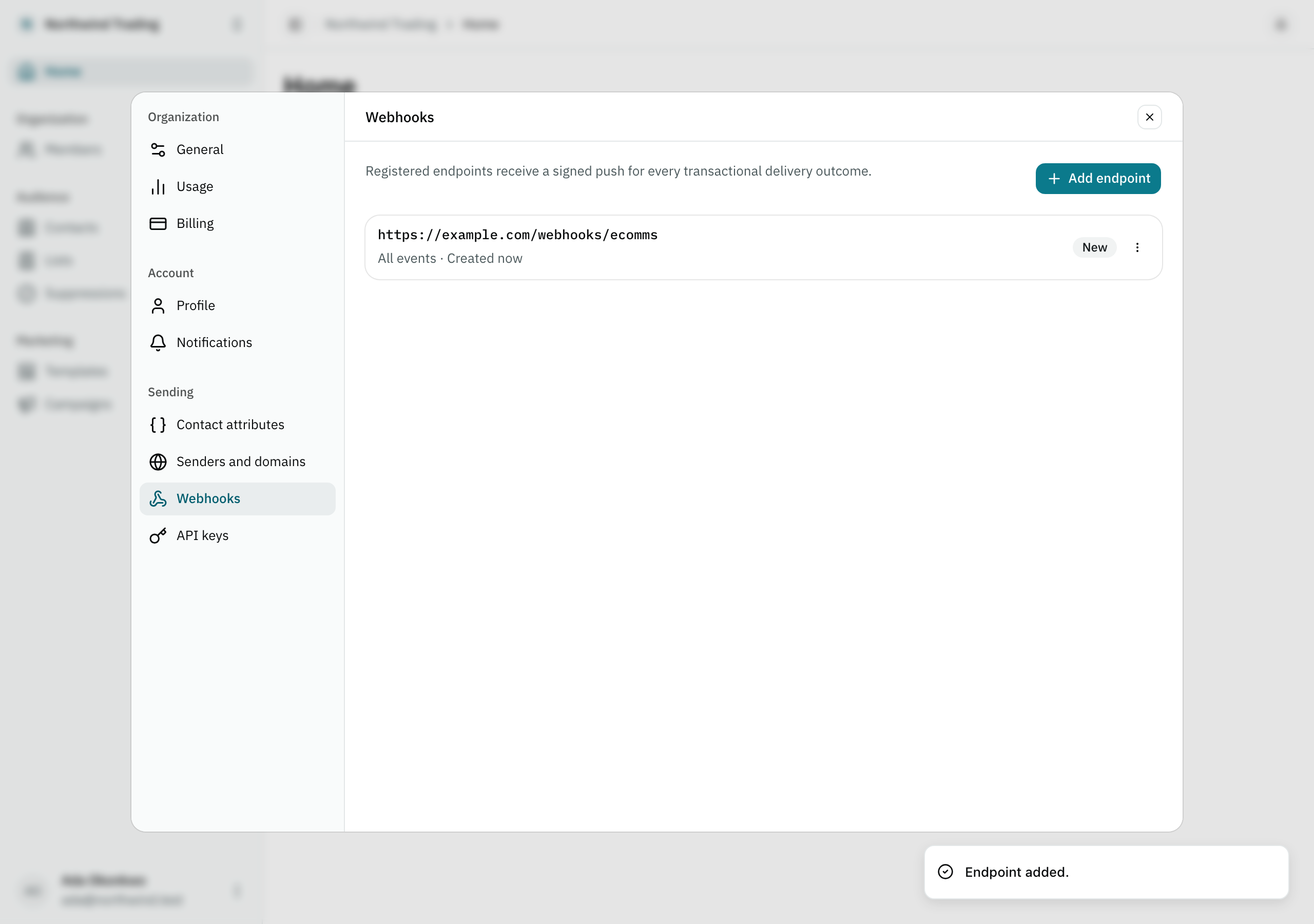 The Settings panel showing an organization's list of webhook endpoints, with one endpoint registered and marked new.